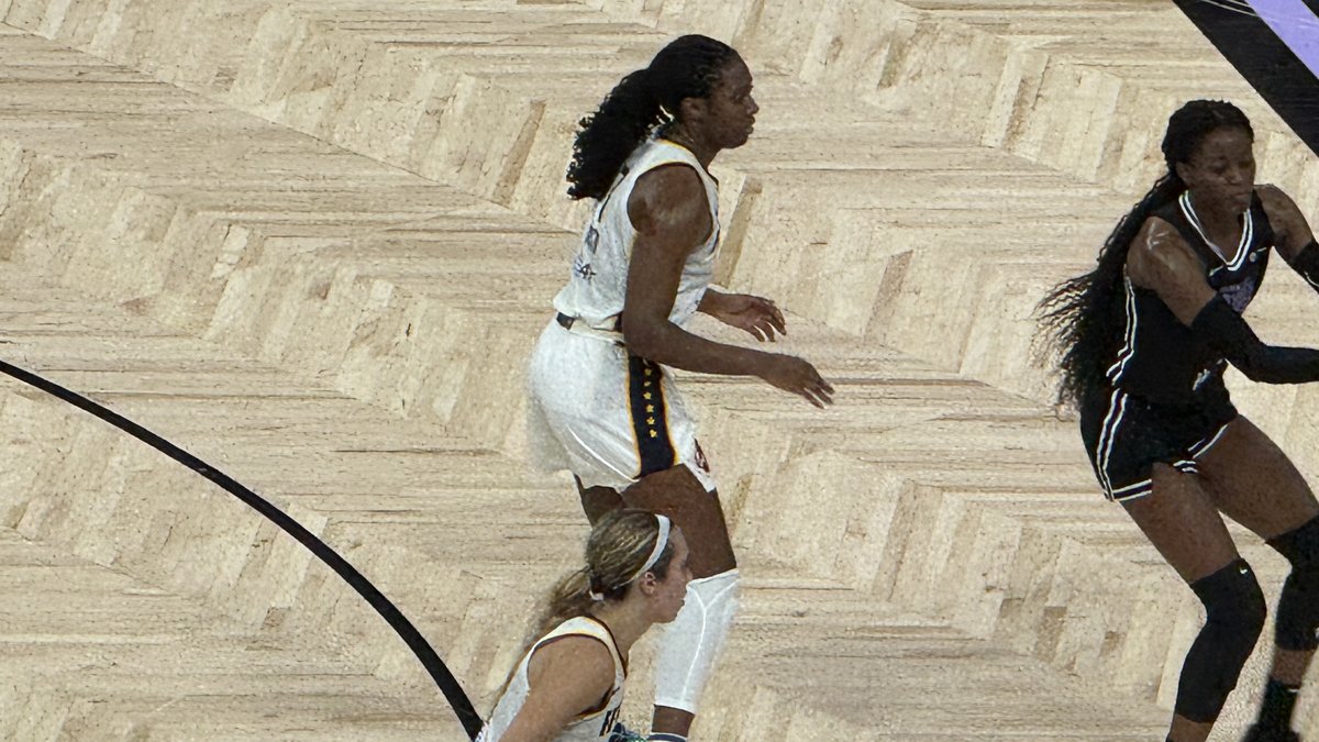 Indiana Fever forward Aliyah Boston in a white Fever uniform moves across the court in a game at Chase Center