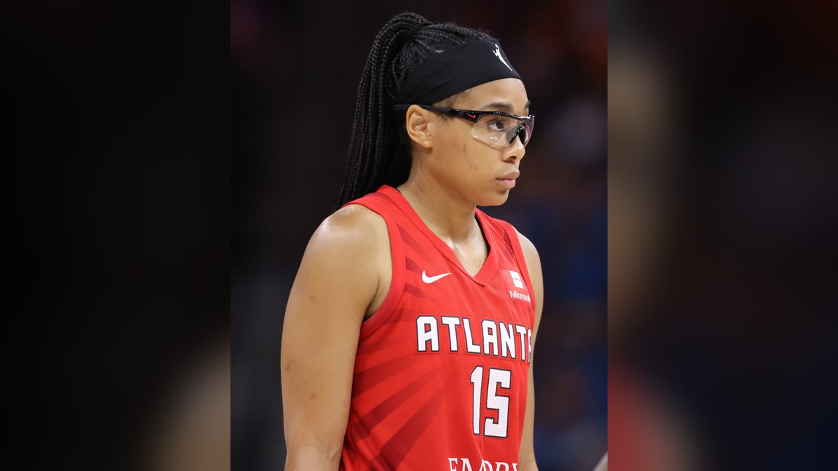 Atlanta Dream guard Allisha Gray in her red No. 15 jersey with a black headband and clear protective glasses during a 2024 game