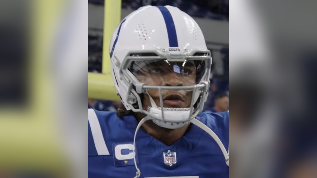 Colts quarterback Anthony Richardson in a white Colts helmet and blue jersey on the field