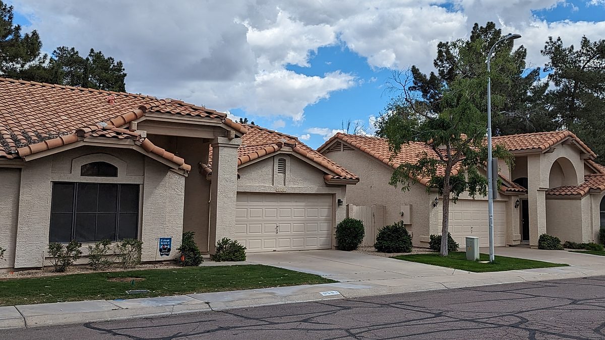 Stucco homes with tile roofs on a residential street in Tempe, Arizona
