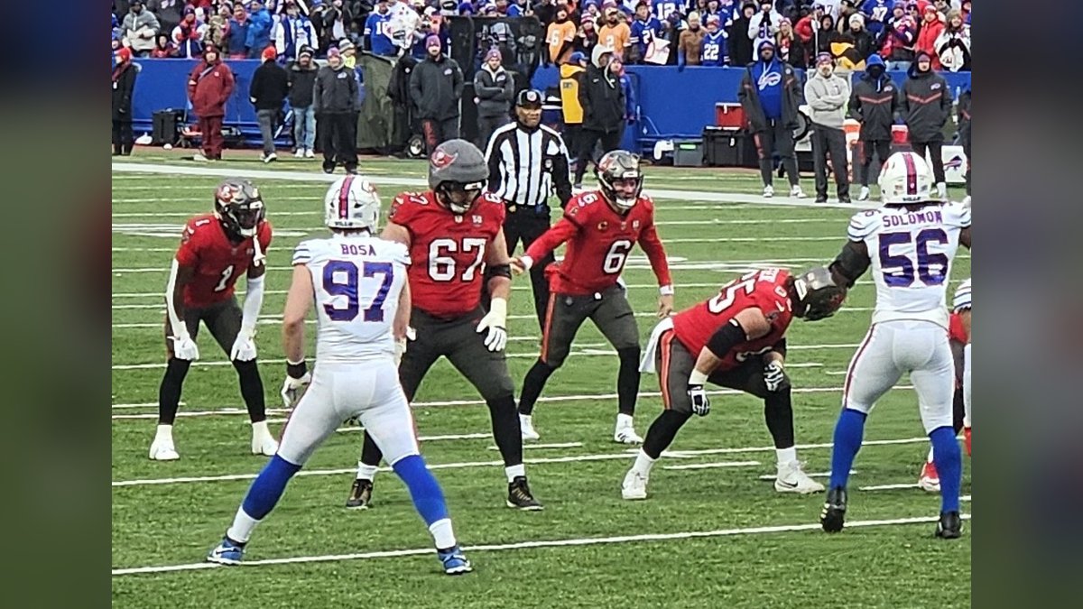 Tampa Bay Buccaneers quarterback Baker Mayfield in a red No. 6 jersey behind his line at the goal line against the Buffalo Bills