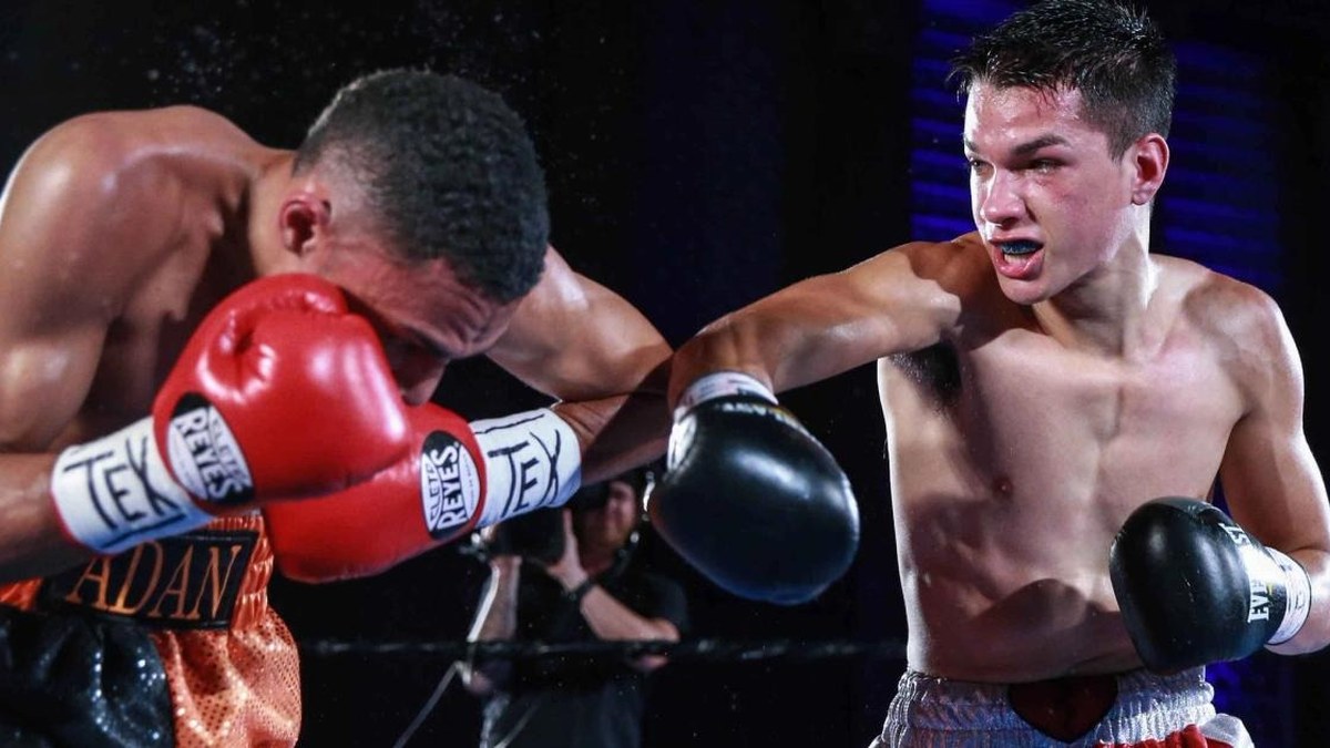 Brandon Figueroa throws a right hand at an opponent whose head is lowered during a fight