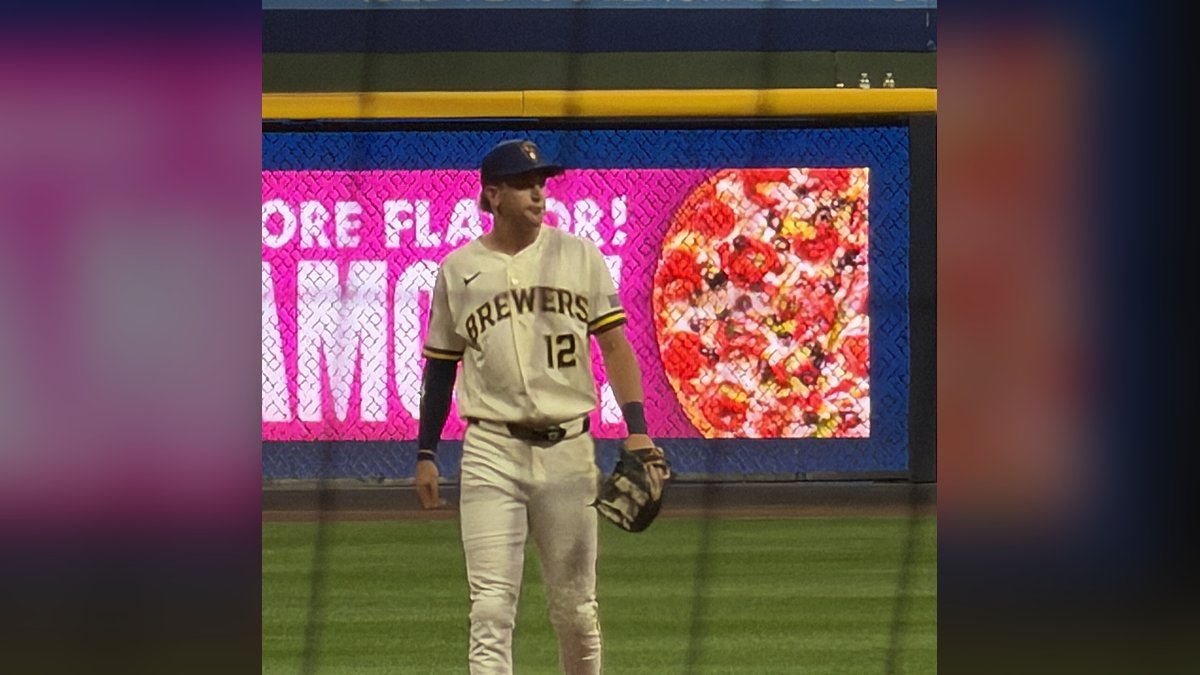Brewers shortstop Cooper Pratt in his cream home uniform with No. 12 standing on the infield with his glove