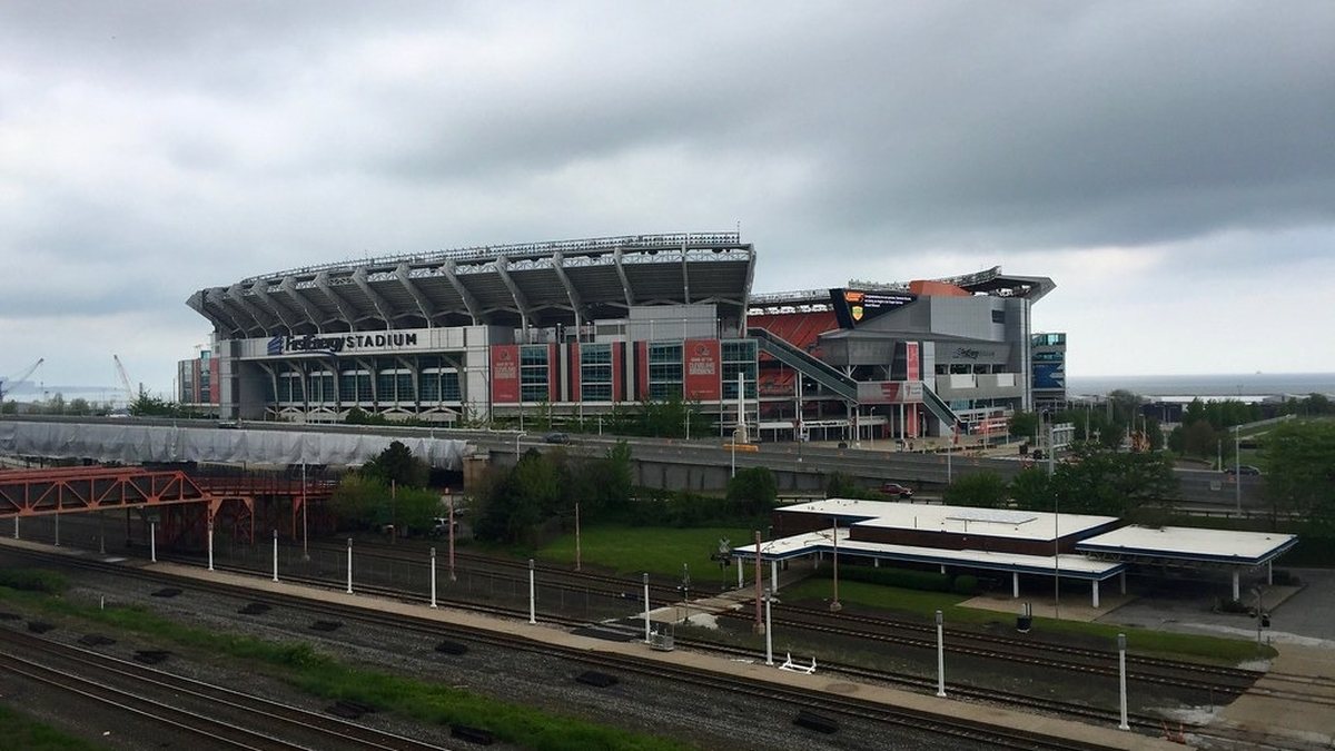 The Browns stadium on the Cleveland lakefront seen across a rail yard on a cloudy day