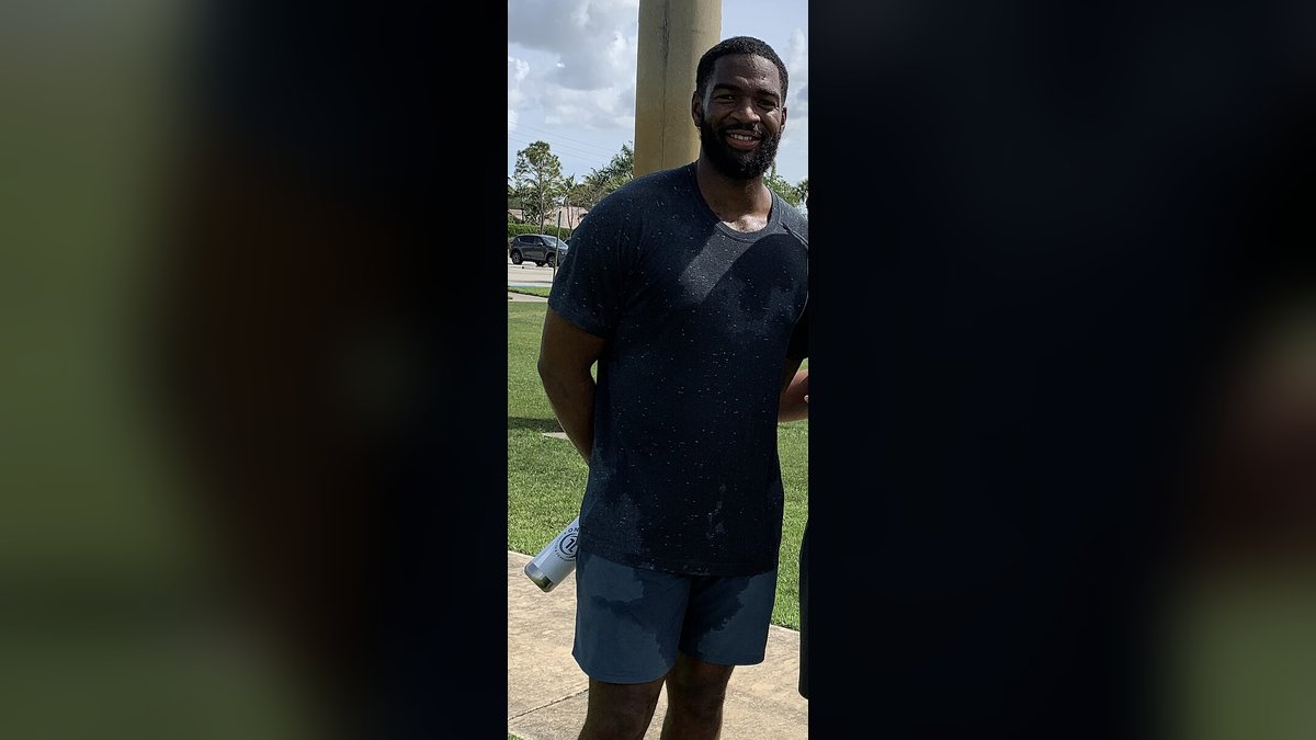 Quarterback Jacoby Brissett stands on a practice field after a throwing session in 2021