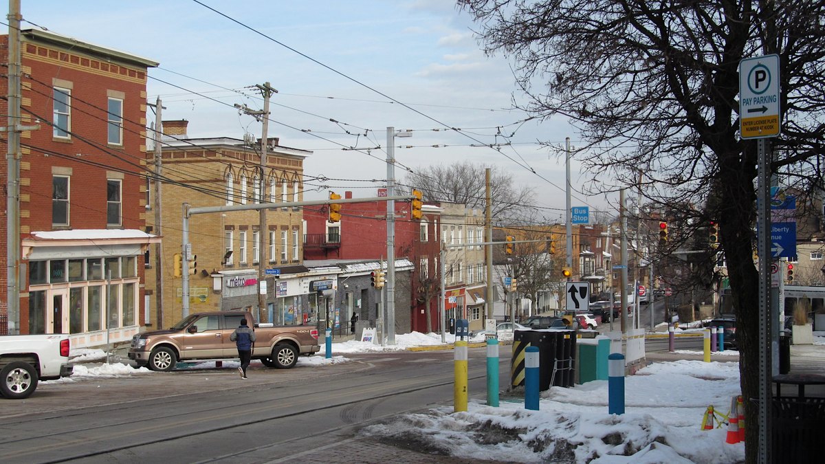 Brick storefronts and row buildings line Broadway in the Beechview neighborhood of Pittsburgh on a winter day