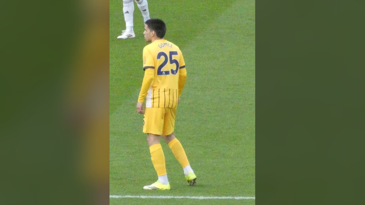 Brighton's Diego Gómez in a yellow No. 25 away jersey stands on the field before a match at Fulham in January 2026