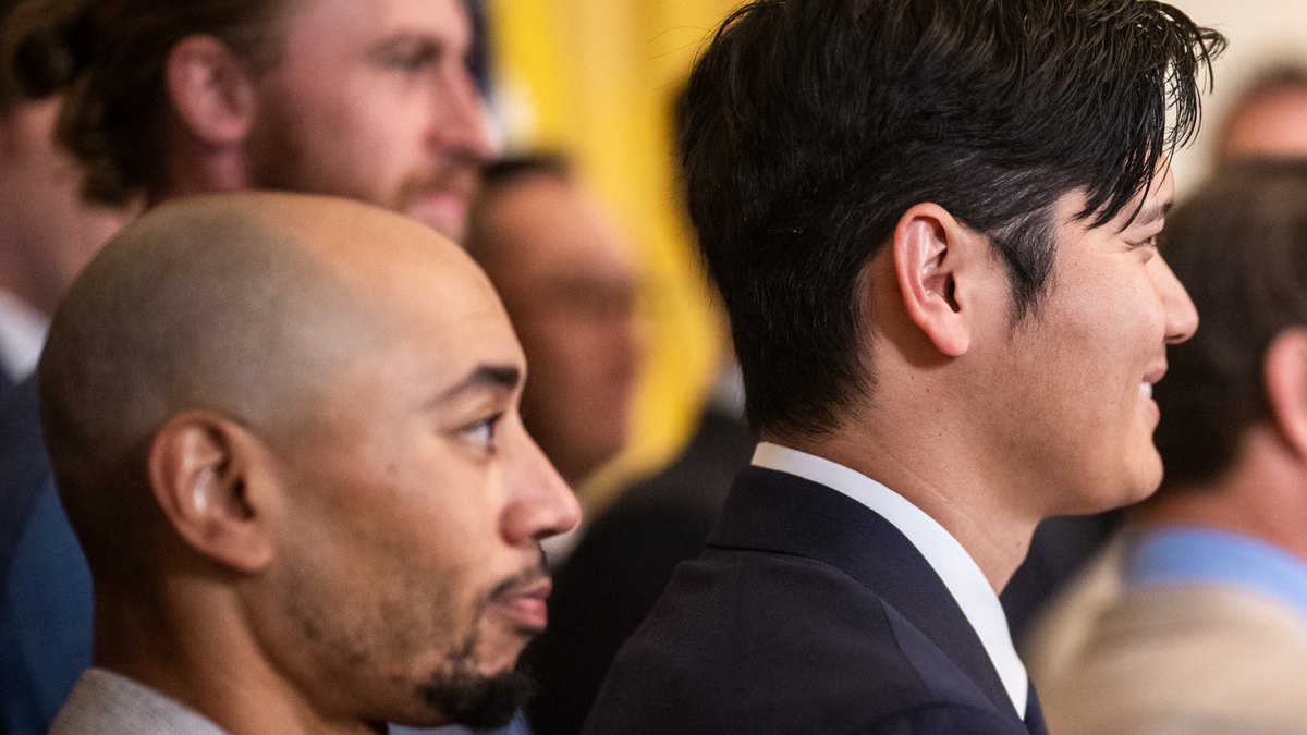 Mookie Betts and Shohei Ohtani in suits stand side by side at the White House in April 2025