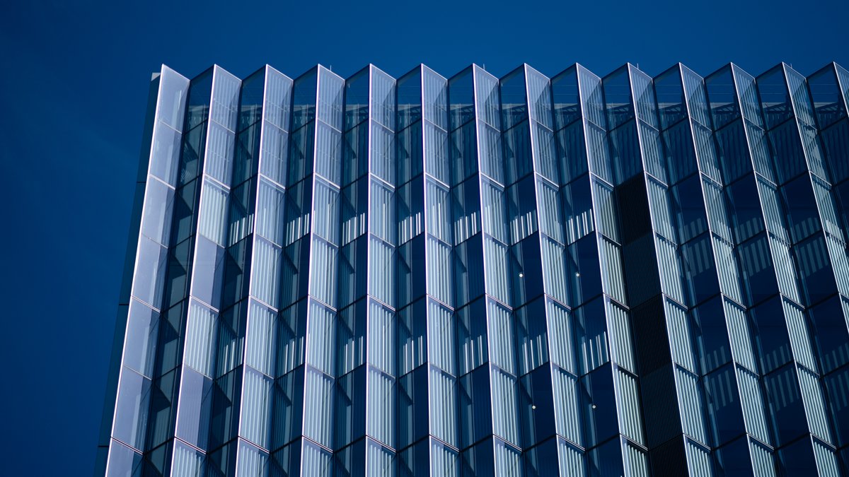 Glass fins of the First Street U.S. Courthouse in downtown Los Angeles rise against a deep blue sky