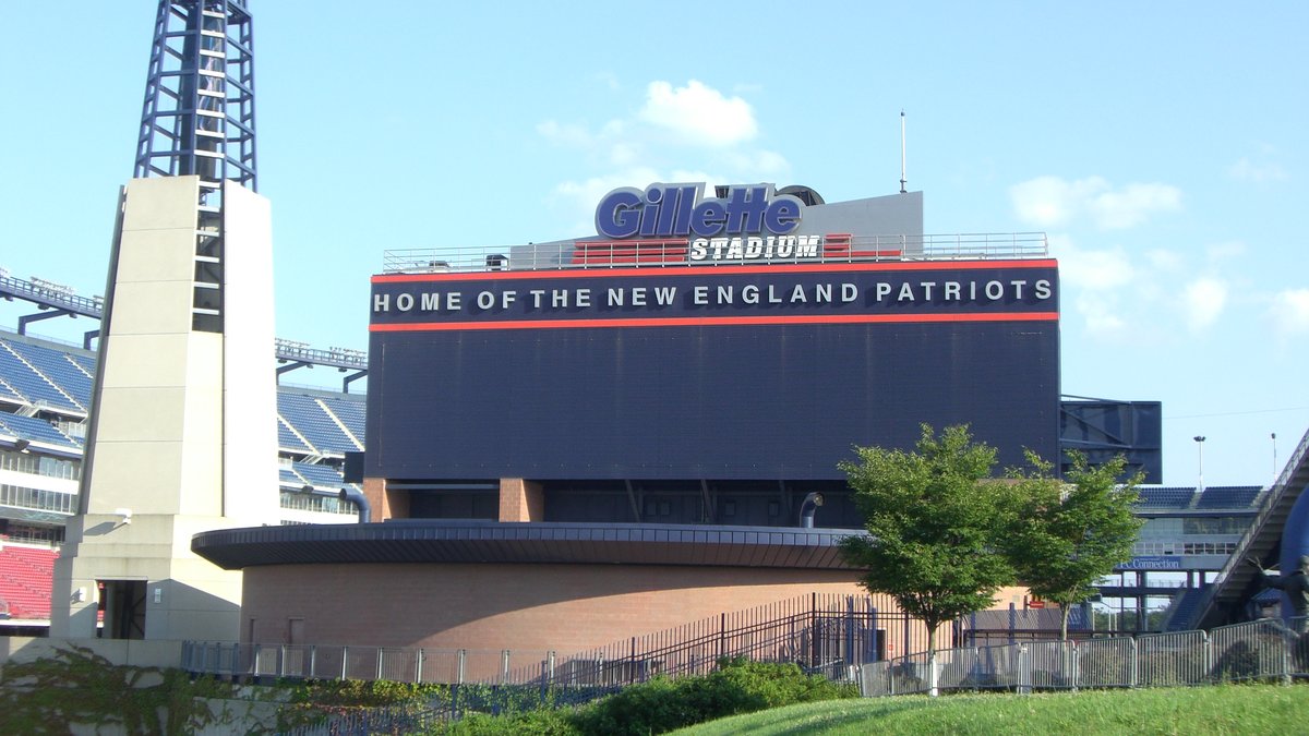 The home of the New England Patriots sign on the outside of Gillette Stadium in Foxborough Massachusetts under a blue sky