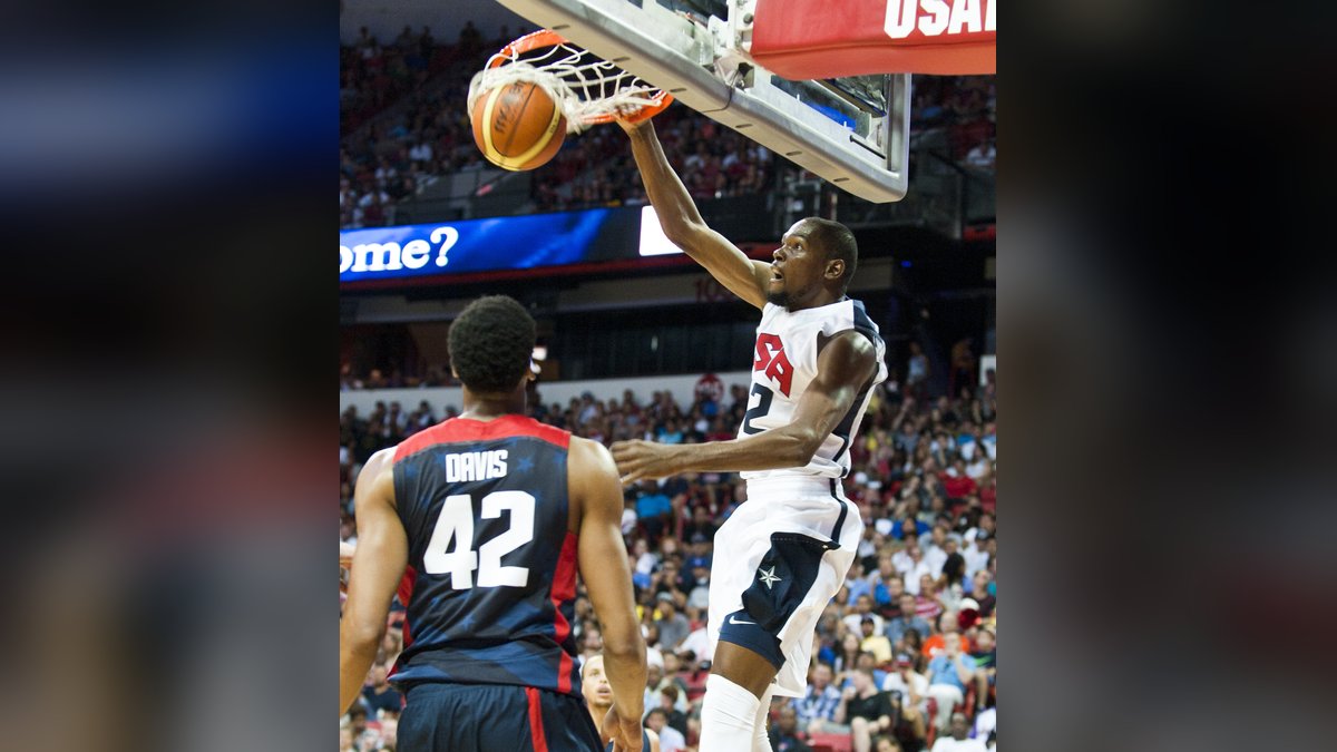 Kevin Durant dunking in a white USA Basketball uniform during a 2014 showcase game in Las Vegas