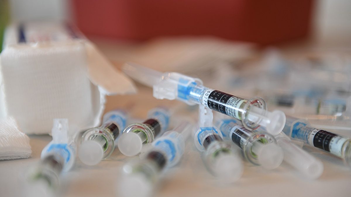 Prefilled flu vaccine syringes lined up on a clinic table