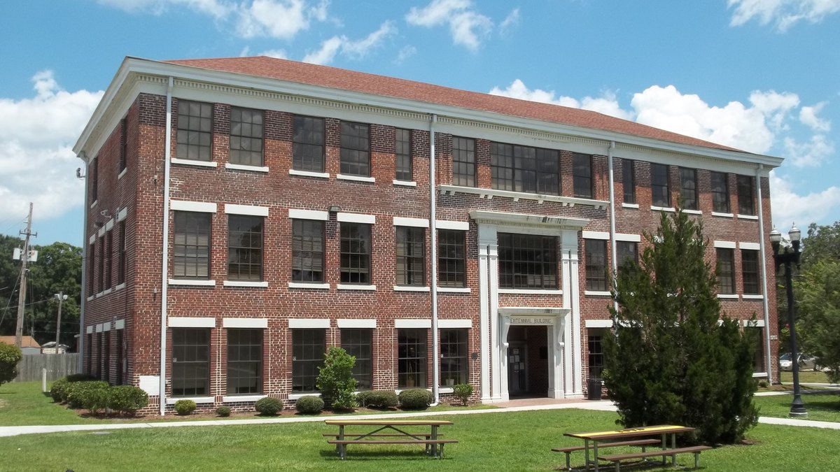 Centennial Hall, a three-story red brick building with white trim and columns on the Edward Waters University campus in Jacksonville, Florida