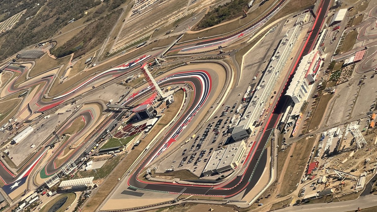 Aerial view of the Circuit of the Americas race track in Austin, Texas with its winding red and white curbs and grandstands