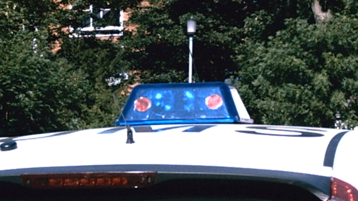 Flashing emergency light bar on the roof of a police patrol car