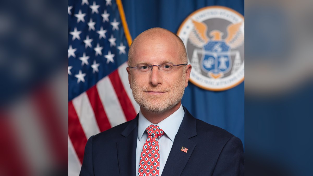 FCC Chairman Brendan Carr in his official portrait in front of an American flag and the agency seal