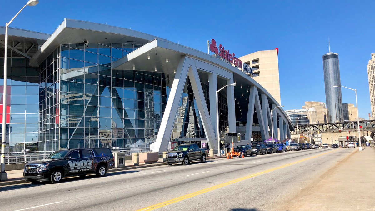 The glass and steel entrance of State Farm Arena, home of the Atlanta Hawks, on a sunny day in downtown Atlanta