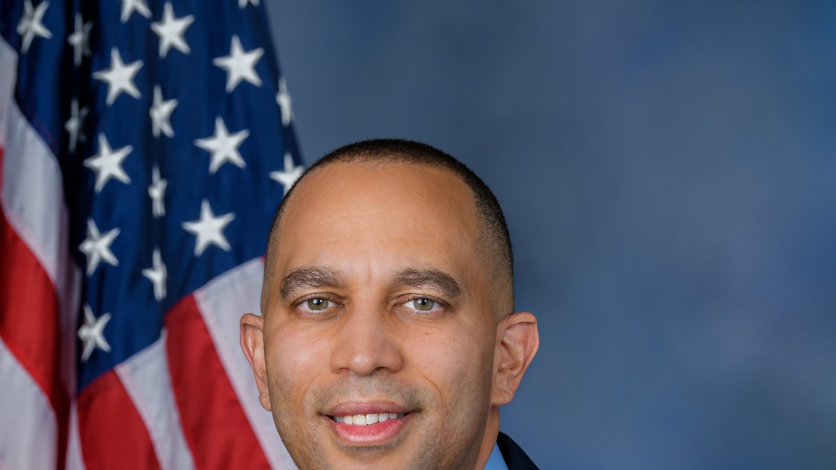 Official portrait of House Democratic Leader Hakeem Jeffries in a dark suit against a soft studio backdrop
