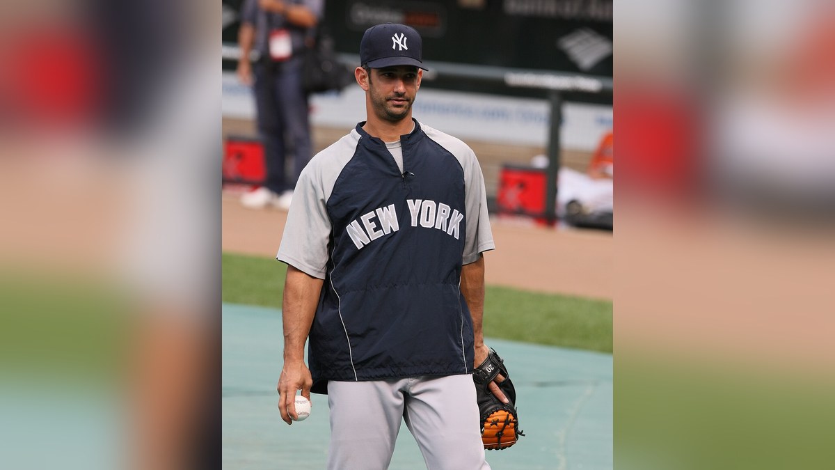 Jorge Posada in a New York Yankees pullover on the field in 2009