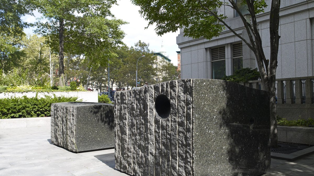 Granite sculpture blocks on the tree-lined plaza outside the Daniel Patrick Moynihan federal courthouse in Manhattan