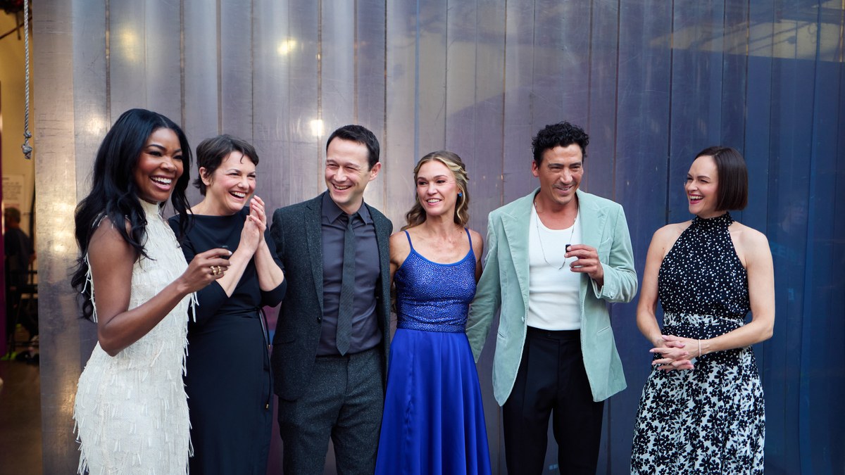 Julia Stiles in a blue dress laughing with five of her 10 Things I Hate About You castmates backstage at Dancing with the Stars