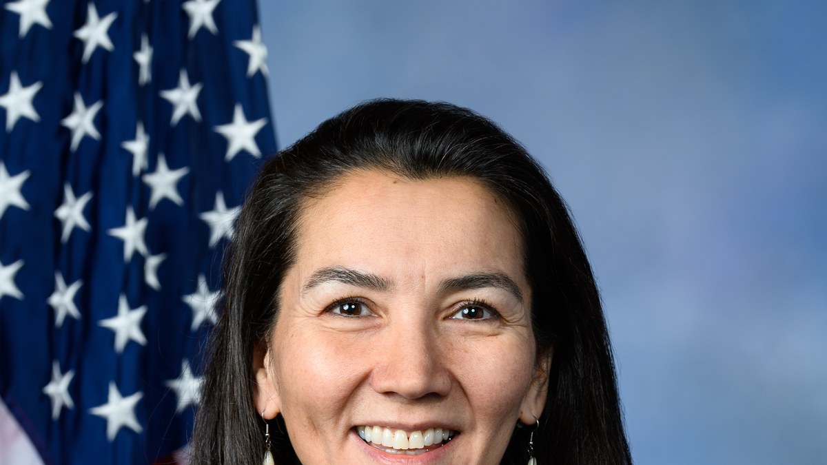Mary Peltola smiling in her official congressional portrait in front of an American flag
