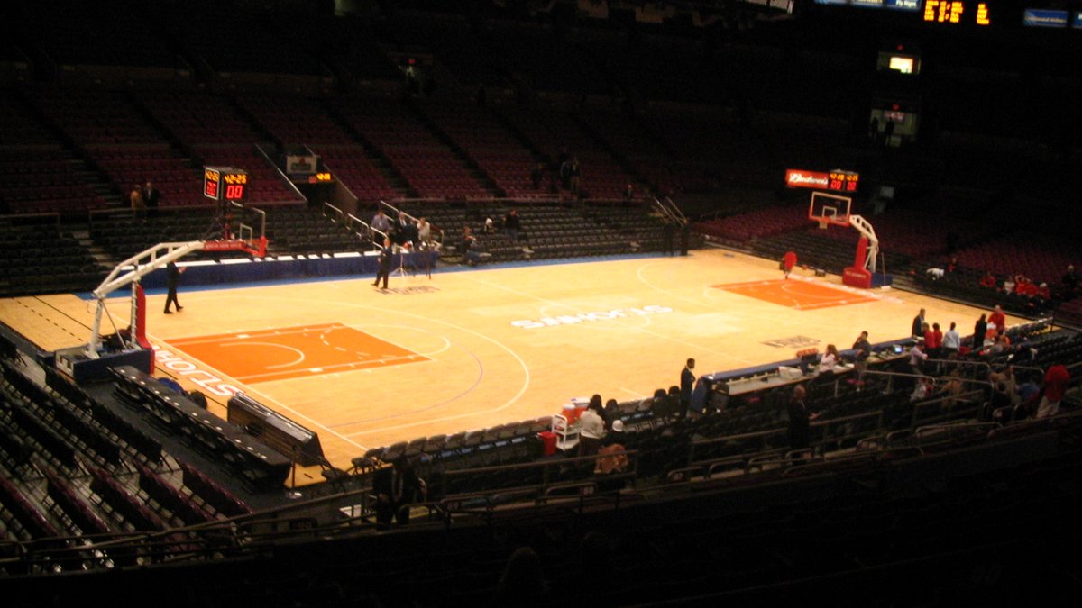The basketball court at Madison Square Garden glows under the arena lights with most of the seats around it still empty