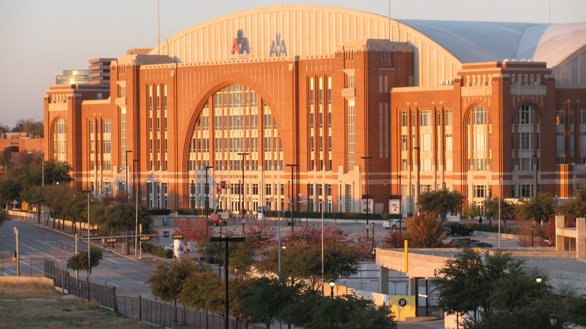 The red brick arched entrance of the American Airlines Center, home of the Dallas Mavericks, at sunset