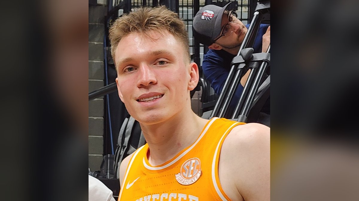 Dalton Knecht in an orange Tennessee jersey smiles after a game against Missouri in February 2024