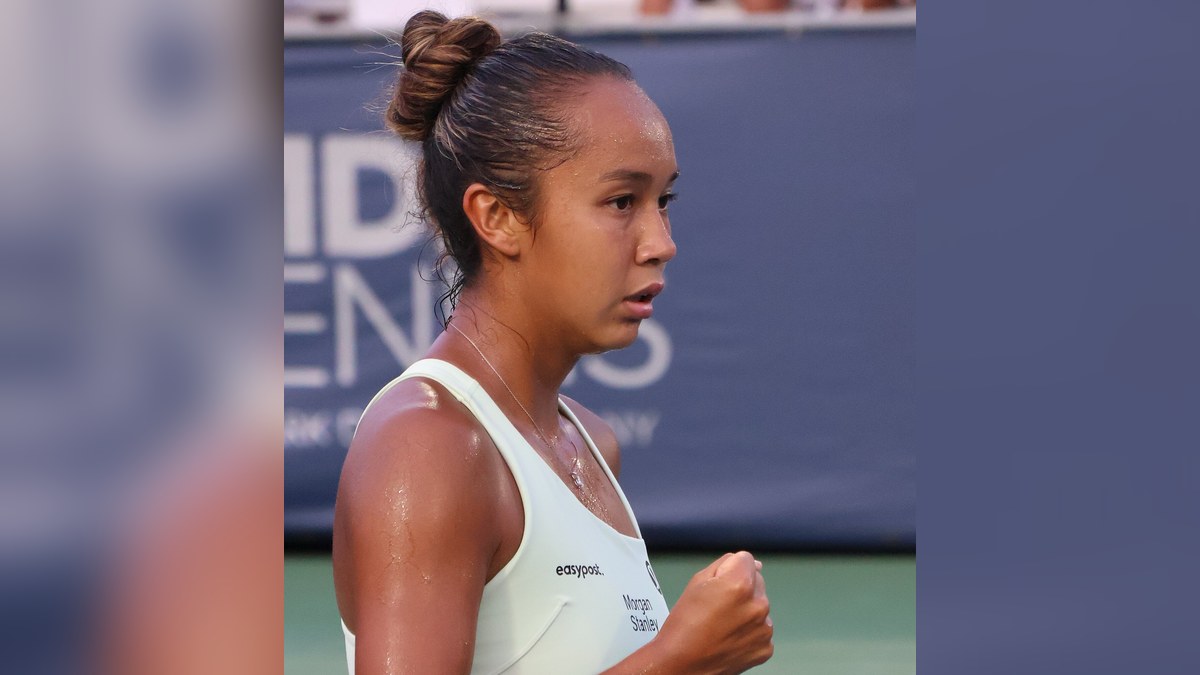 Leylah Fernandez pumping her fist in a white tank top during a match at the 2023 DC Open