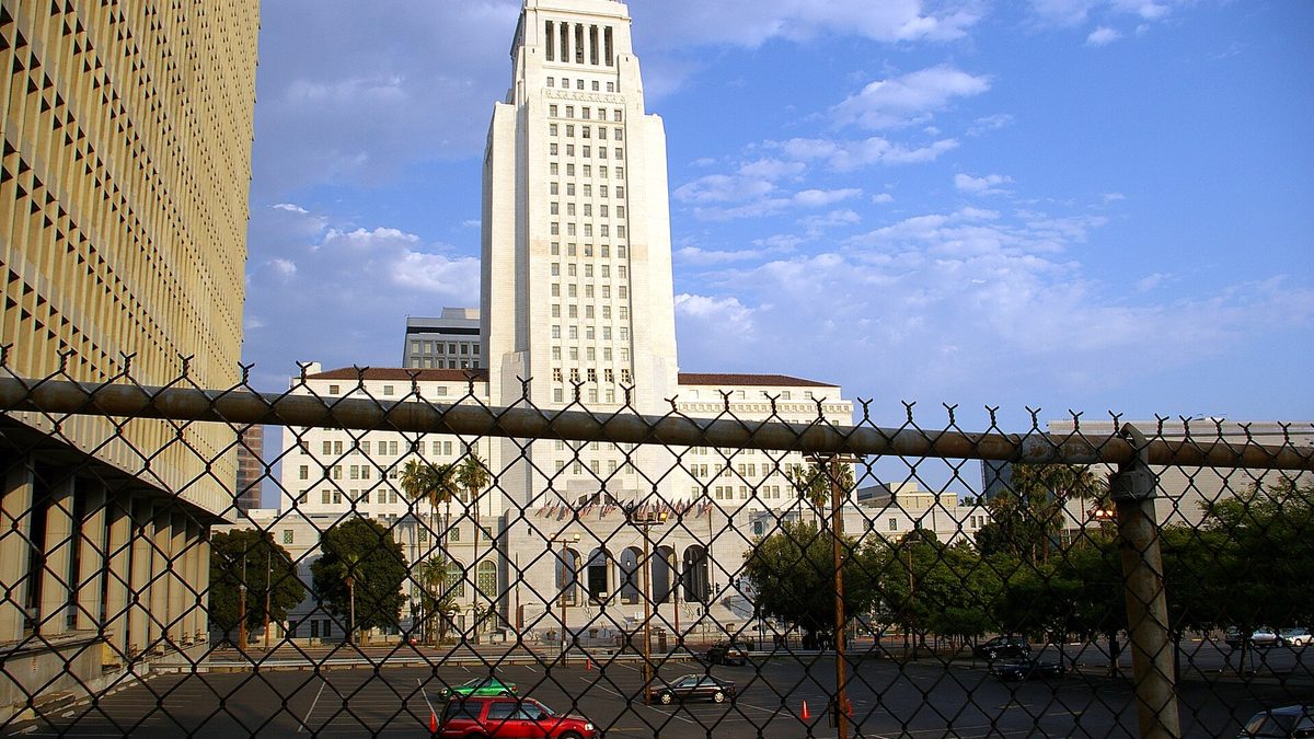 Los Angeles City Hall seen through a chain-link fence