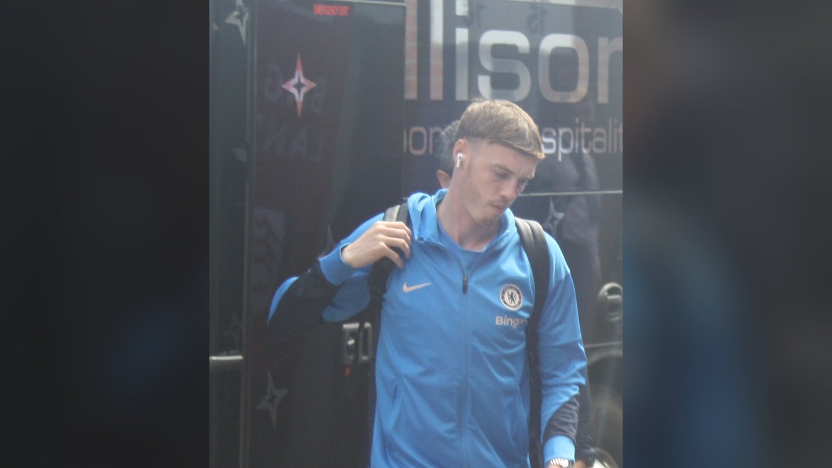 Cole Palmer in a blue Chelsea track jacket and shorts with a backpack on his shoulder arriving for a Premier League match
