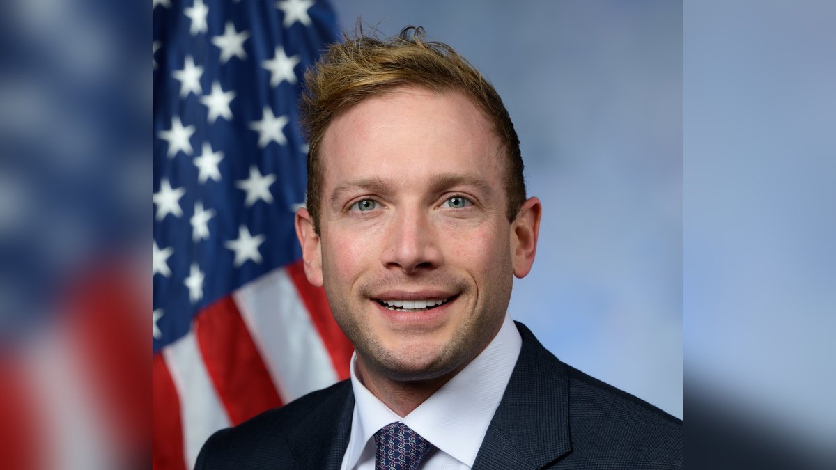 Official congressional portrait of Ohio Rep. Max Miller in a dark suit in front of an American flag