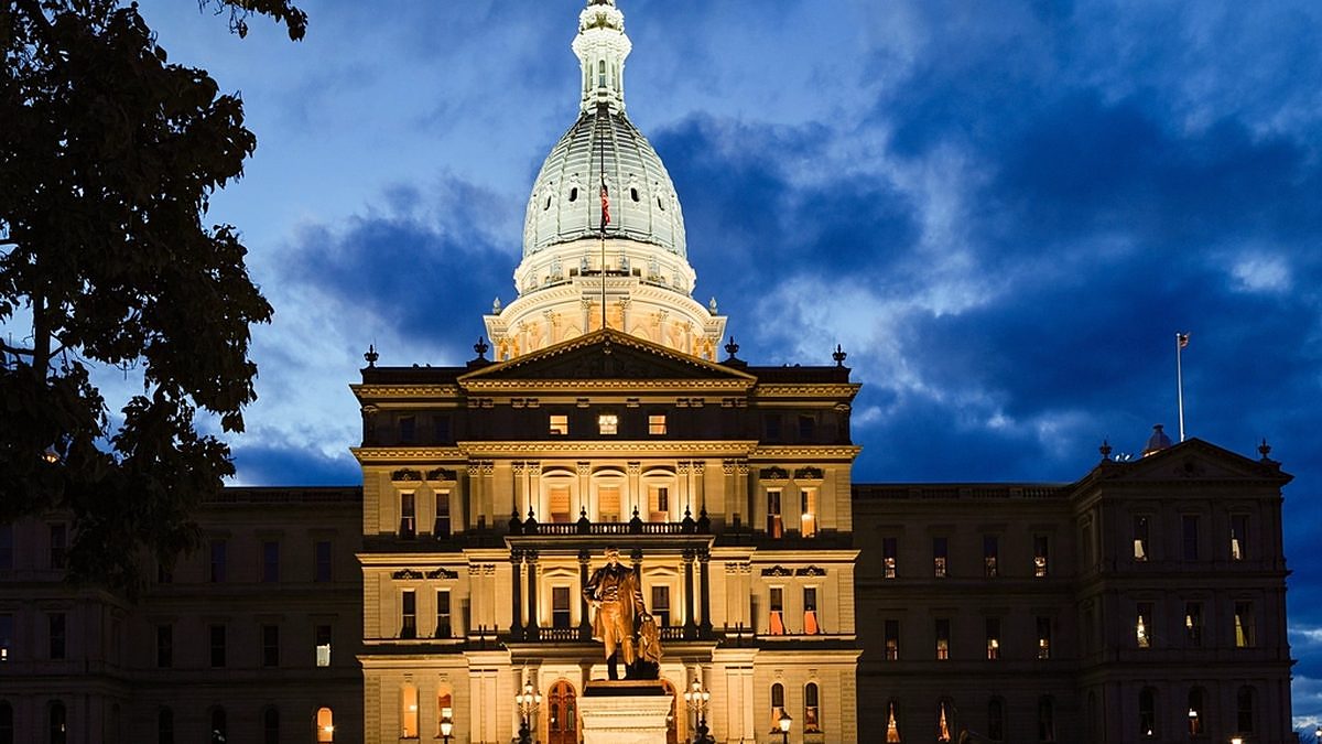 The Michigan State Capitol dome in Lansing against a blue sky
