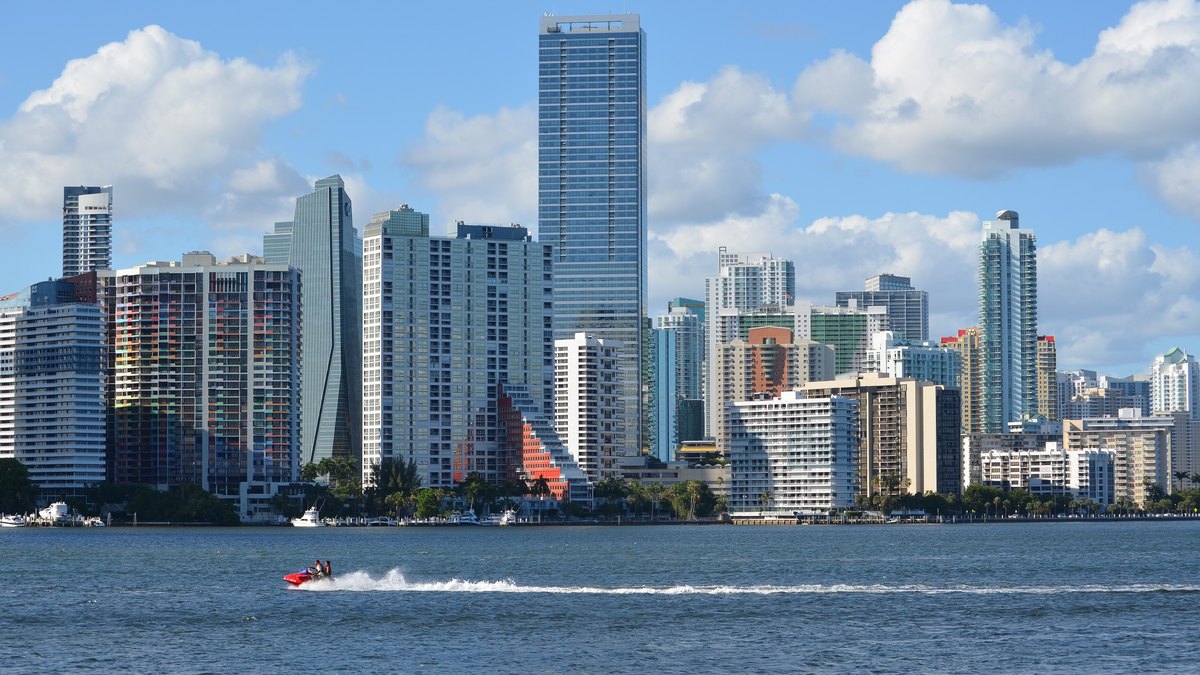 Brickell high-rise towers along Biscayne Bay in Miami under a blue sky