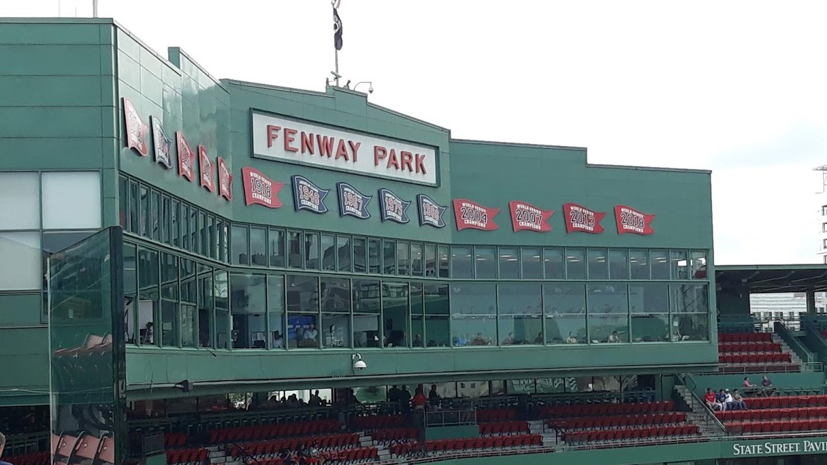 The green Fenway Park press box with red pennants above the seats at Boston's ballpark