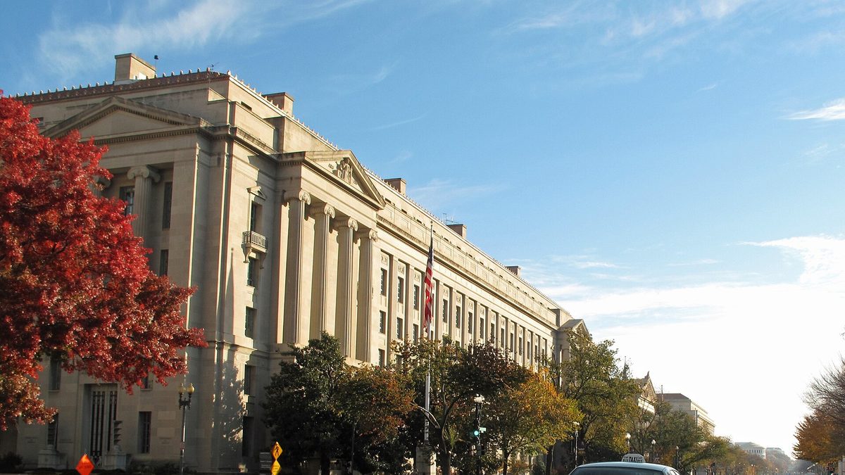 The Robert F. Kennedy Department of Justice Building in Washington, framed by autumn trees