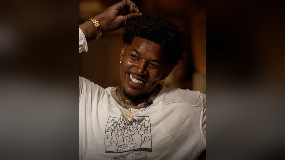 Nick Young smiling in a white T-shirt