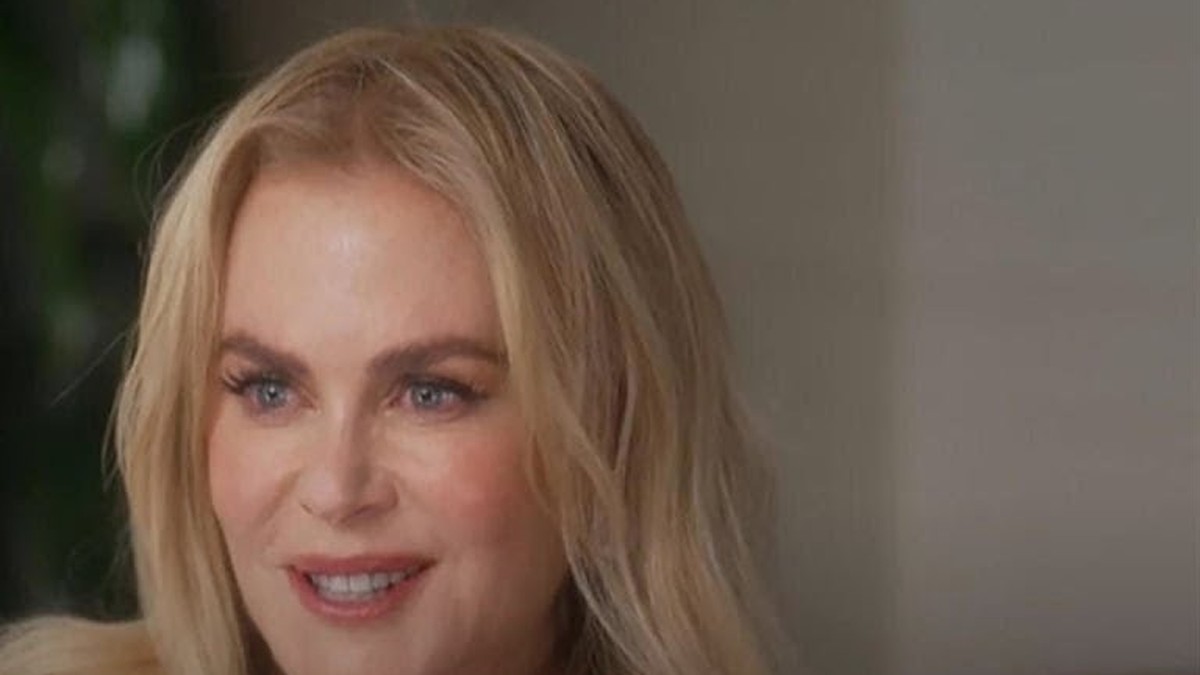 Nicole Kidman smiling with long blond hair during a sit-down interview