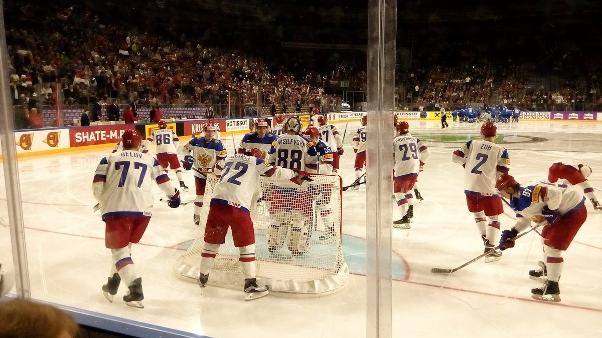 Russian national team players in white and red jerseys gathered in front of the net during a 2017 IIHF World Championship game
