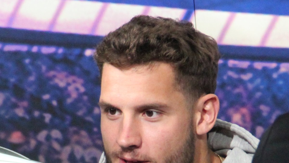 49ers defensive end Nick Bosa in a gray hooded sweatshirt looks on during a fan event