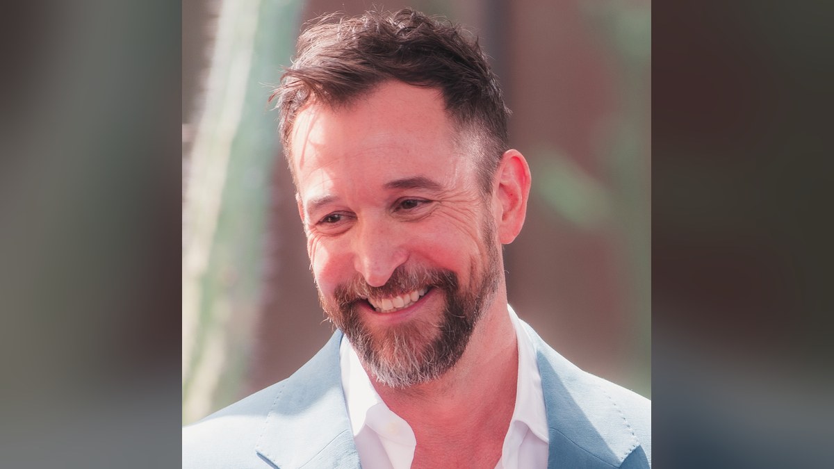 Noah Wyle smiling at his Hollywood Walk of Fame ceremony
