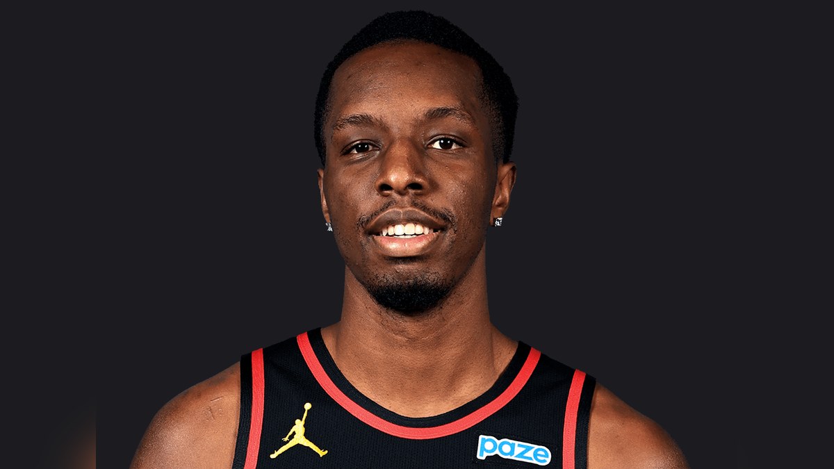 Onyeka Okongwu smiling in a black Atlanta Hawks jersey