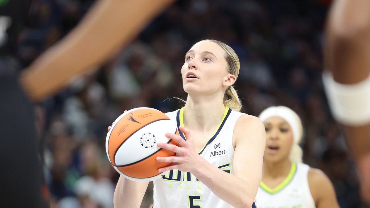 Paige Bueckers lining up a free throw in her white number 5 Dallas Wings jersey