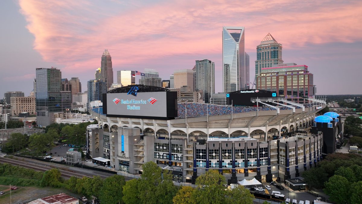 Bank of America Stadium sits in front of the Charlotte skyline at sunset