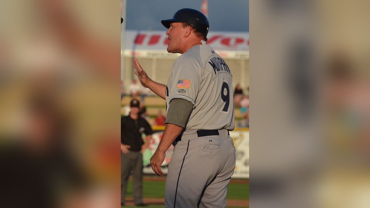 Pat Murphy in uniform number 9 coaching on the field in 2013