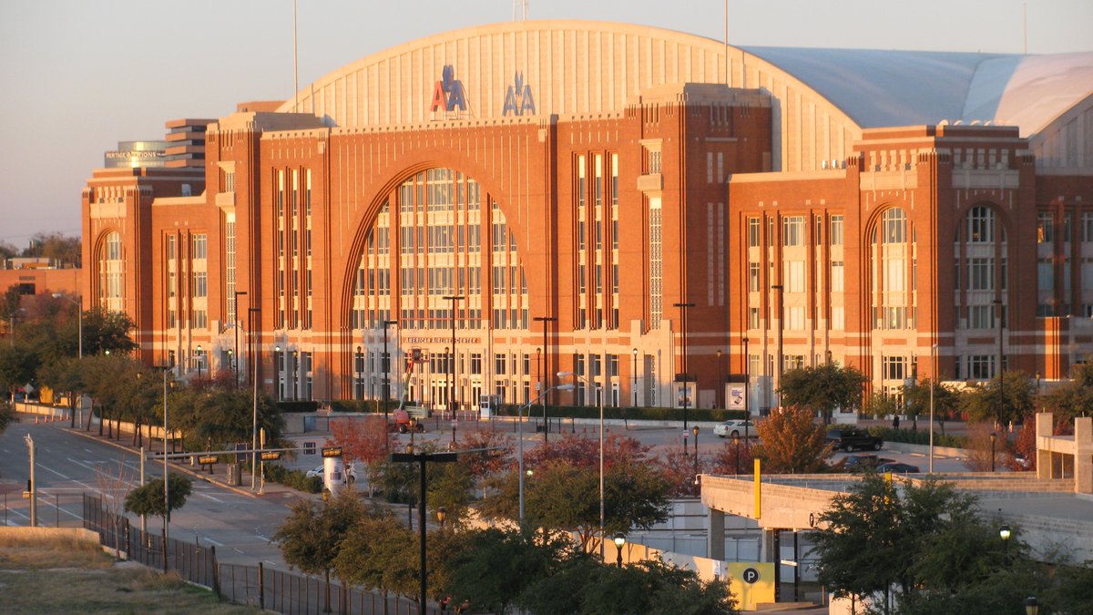 The brick and glass American Airlines Center arena in Dallas glows in late afternoon sunlight