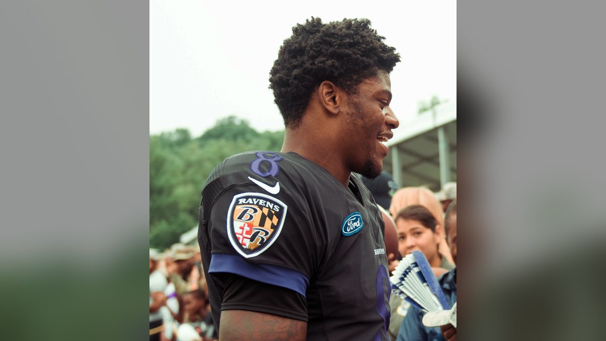 Lamar Jackson in a black Ravens jersey at a training camp practice