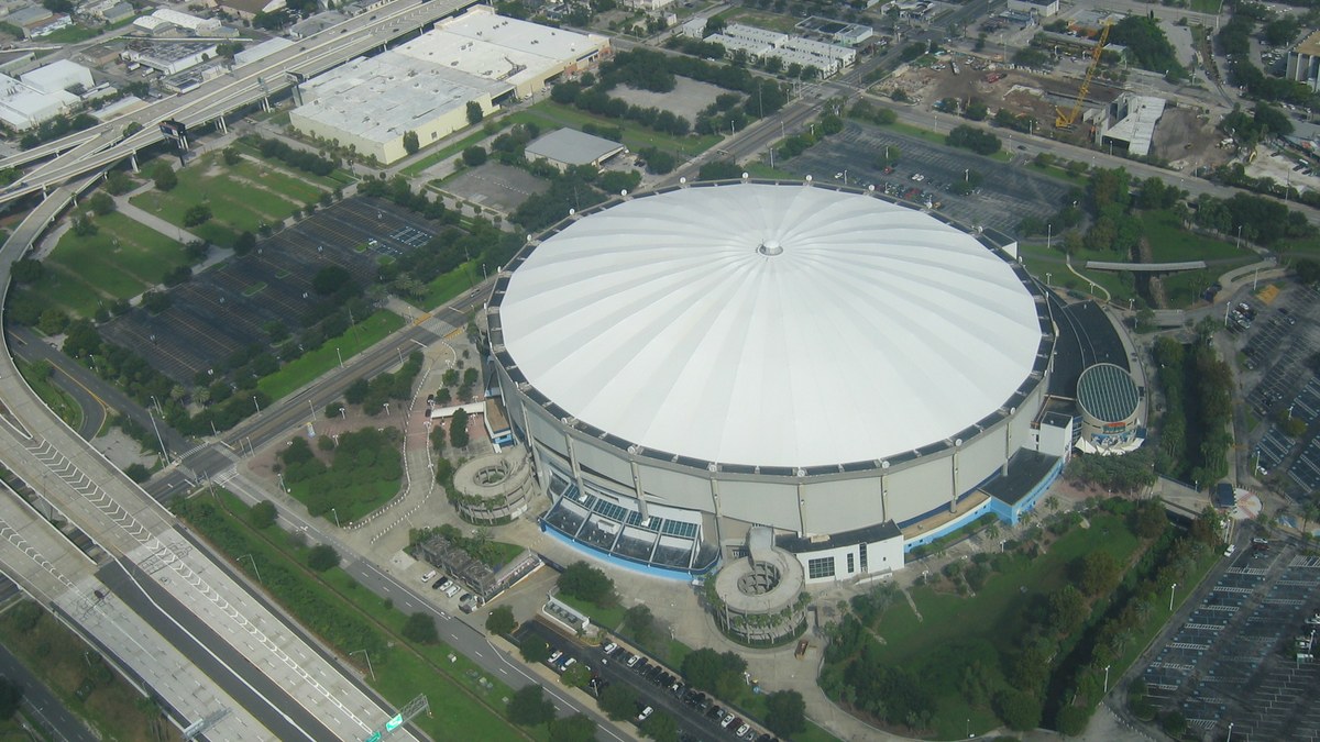 Aerial view of the white dome of Tropicana Field in St. Petersburg surrounded by parking lots and highways