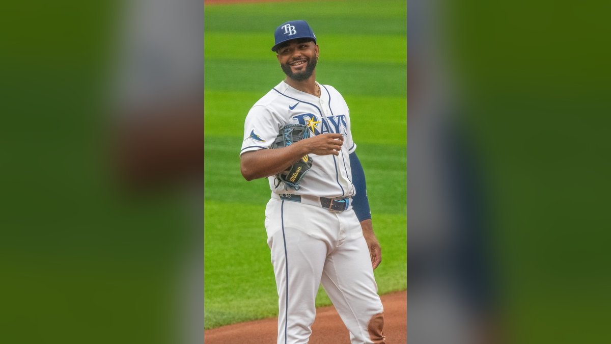Tampa Bay Rays third baseman Junior Caminero smiles on the field in a Rays home uniform during a June 2026 game